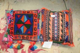 A pair of vintage handmade Afghan salt bags, made up as cushions for conservatory or sofas,