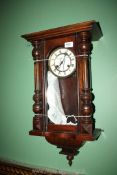 A Victorian wall Clock with Roman numerals. 26 1/2'' high overall x 14'' wide.