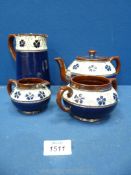 A Doulton style four piece Teaset in navy and cream with blue flowers (some a/f).