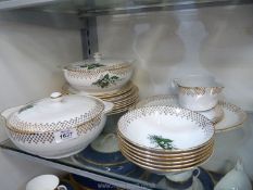 A white ground, lily of the valley pattern dinner service comprising two tureens,