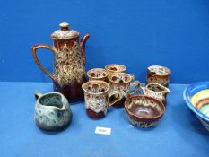 A Studio Pottery coffee set by Fosters of Cornwall in mottled brown, four mugs, coffee pot etc.