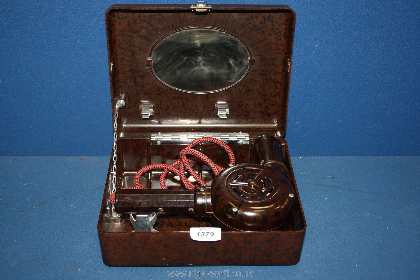 A cased Bakelite hairdryer with mirror, 10 1/2" wide x 8" deep x 4 1/4" high.