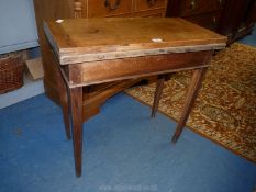 A Mahogany flap-over Card Table standing on tapering square legs,