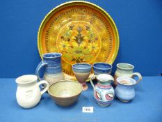 A quantity of studio pottery including multi coloured charger (edge of charger slightly a/f),