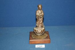 A very rare and early Chinese bronze figure of the lady immortal He Xiangu finely cast with flowing