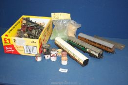 A quantity of train parts to include wheels, paint, three carriages (in need of restoration) etc.