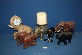 A quantity of Elephant ornaments including resin mother with calf clock, ebonised, metal, Treen,