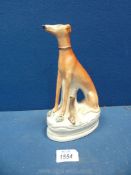 A fine and large Staffordshire figure of a seated greyhound, a hare at its feet, circa 1840,