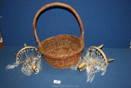 A pair of brass and glass wall lights with glass droplets.