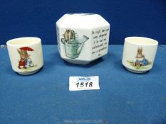 A Wedgwood Peter Rabbit money box and two Bunnykins egg cups.