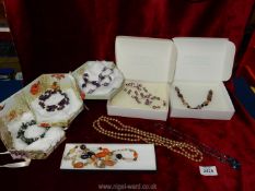 A quantity of costume jewellery including polished stones, beads, bracelets etc.