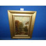 A framed oil on board depicting a lady walking through a wood, signed lower left by G. Harris.