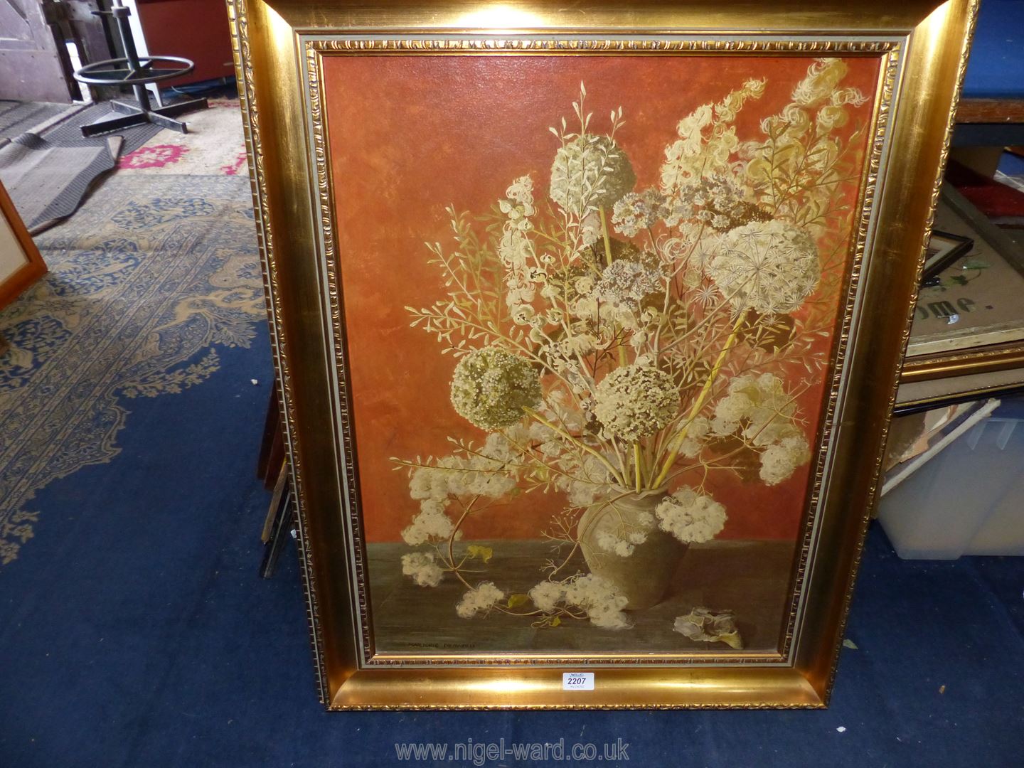 A gilt framed print on board depicting a vase of flowers, signed lower left 'Marjorie Drawbell'.