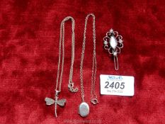 A silver dragonfly pendant and chain, stamped 925, an oval locket and chain,