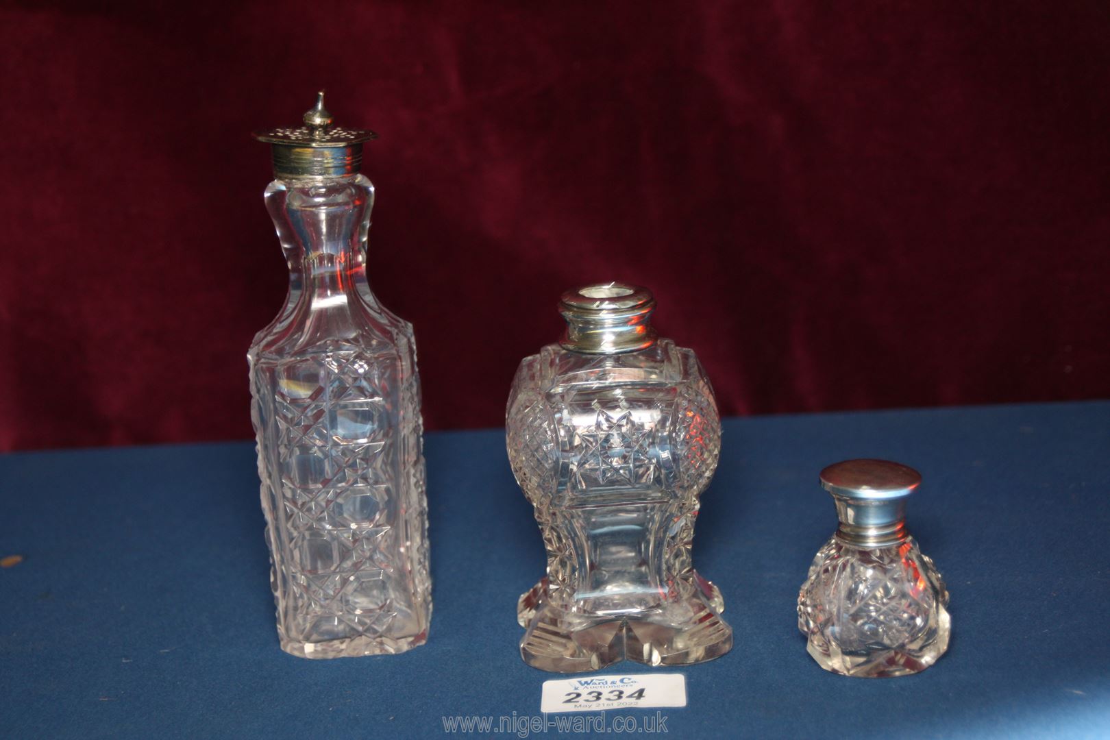 Two glass perfume bottles, one with silver lid Birmingham 1923, maker 'WA' (William Adams),