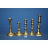 Five brass candlesticks, 2 having side push-ups.