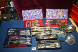 A quantity of plated cutlery including community, steak knives and forks, a large ladle,