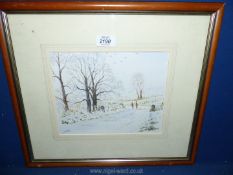 A framed and mounted Watercolour of a winter landscape with figures walking down a lane.