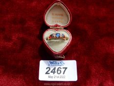 A heart shaped red leather bound presentation boxed 9 carat gold ladies ring set with four chip