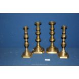 Two pairs of brass candlesticks, 10" and 9 3/4" tall.