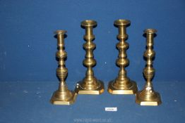 Two pairs of brass candlesticks, 10" and 9 3/4" tall.