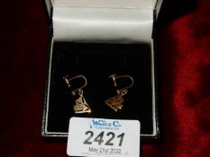 A pair of 9ct gold screw back earrings in the form of sailing boats.