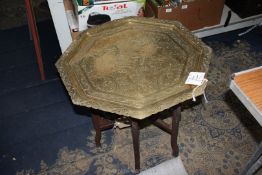 An octagonal Benares Table the brass top having engraved decoration, 24" x 24" x 22" tall.