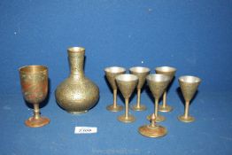 A small quantity old ornate Eastern style items including six goblets with matching vase and a