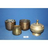 Three brass canisters with engraved decoration and one lidded pot.