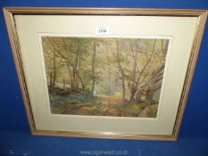 A framed and mounted Arthur Miles watercolour of figures in a woodland scene.
