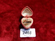 A deep pink leather bound heart shaped presentation boxed 18 carat gold ladies ring set with two