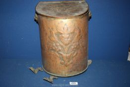 A brass coal scuttle with lion handles (no rings) and floral engraving and embossing to front and