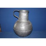 A large pewter water jug 19" tall.