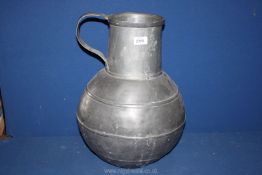 A large pewter water jug 19" tall.