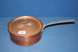 A copper saucepan with lid.