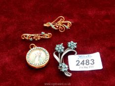 Three costume brooches to include; white metal set with pale blue stones,