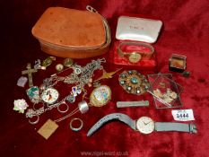 A brown leather case and contents of silver and other brooches, Danish necklace,