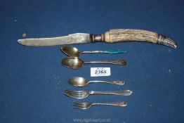 A carving knife with horn handle having silver collar and tip,