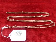 A long 9 carat gold chain, 62" long with small faceted balls at intervals.