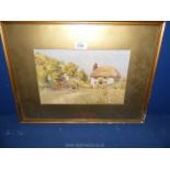 A framed and mounted Watercolour depicting a thatched cottage with figures in the garden.