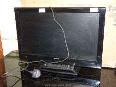 A 'Sharp' 21" flat screen TV with remote.