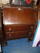 A dark wood bureau with key.