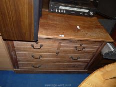 An Edwardian Satinwood chest of two over two drawers with drop handles.