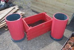 A rectangular planter and two tall red wooden planters.
