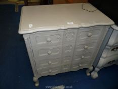 A modern painted hall cupboard with four drawers.
