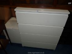 A white bedroom set with four drawers and a bedside cabinet.