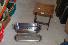 A fish kettle and small table.