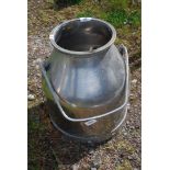 A stainless steel milk bucket.