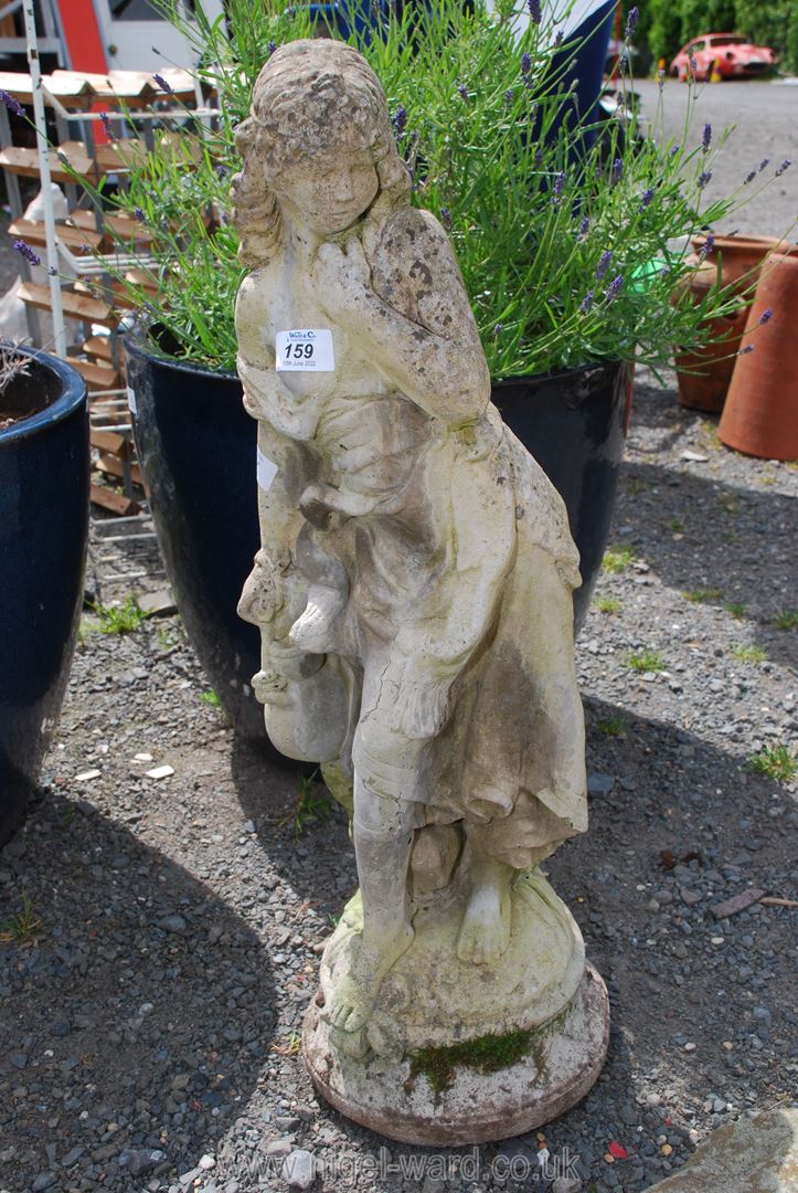 A concrete garden ornament of a Lady.