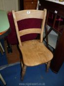 An Elm seated bar back kitchen chair.